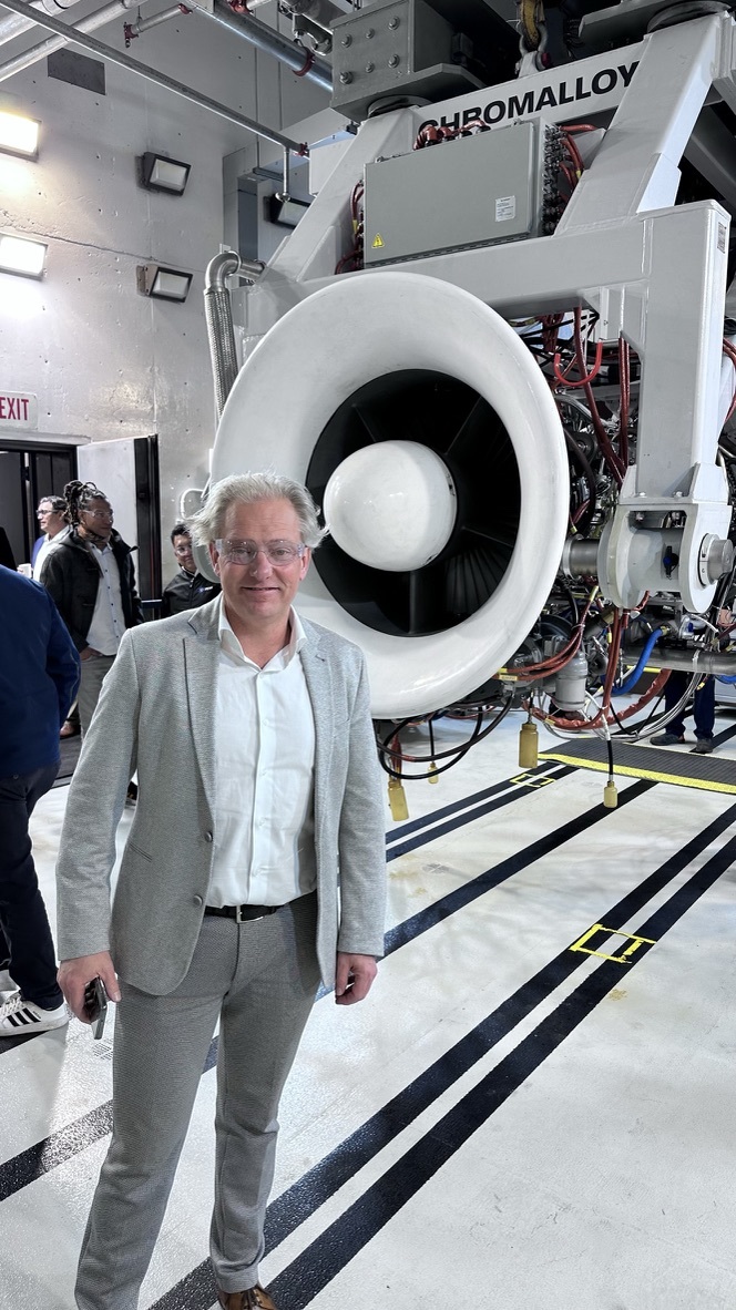 Patrick Morcus beside a turbine in an industrial setting